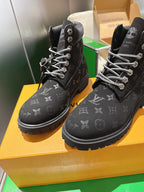 Louis Vuitton monogram lace-up boots, pair view on yellow box with laces