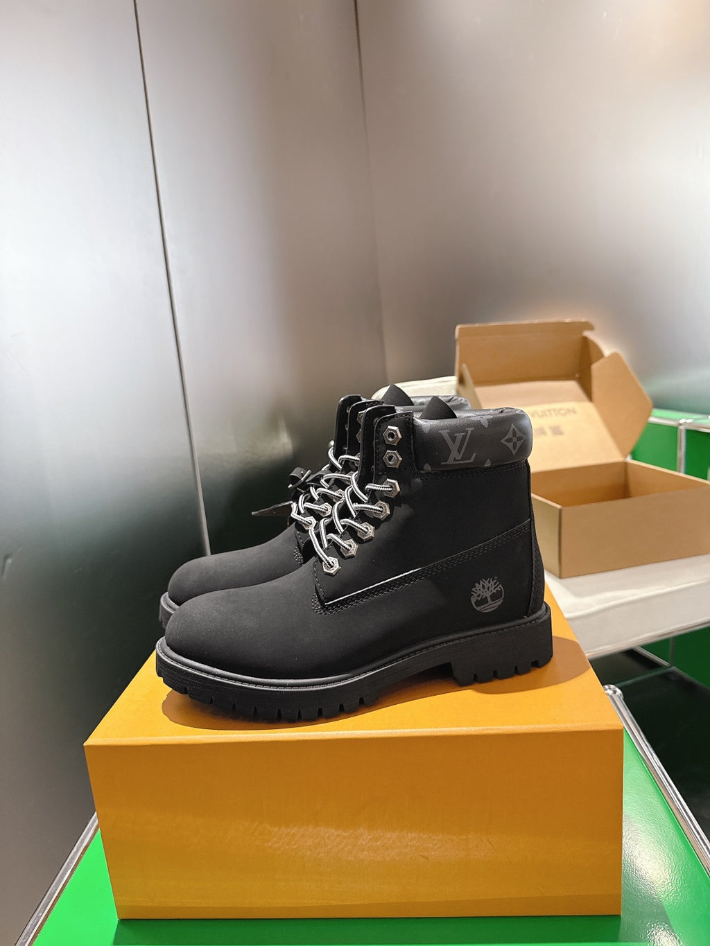 Louis Vuitton unisex black lace-up boots, side view with metal eyelets