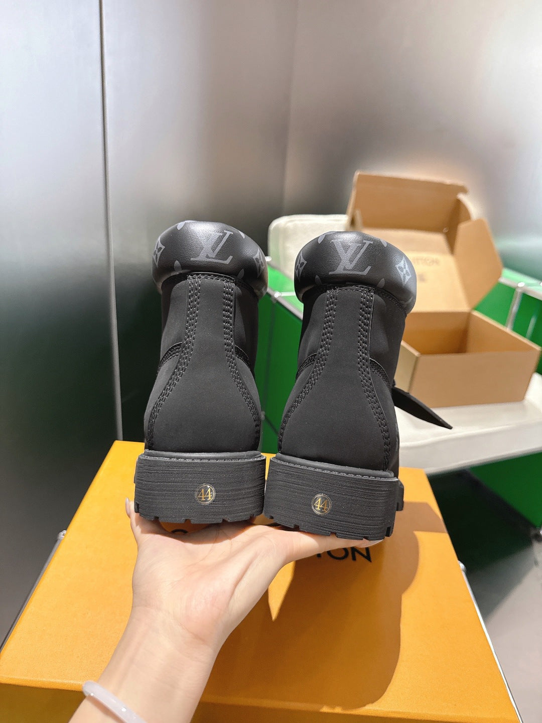 Louis Vuitton unisex black boots heel view, showing branding on back