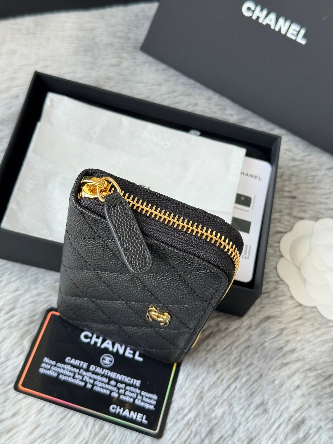 Small bag top view with gold-tone chain hardware and CC turn-lock on black texture