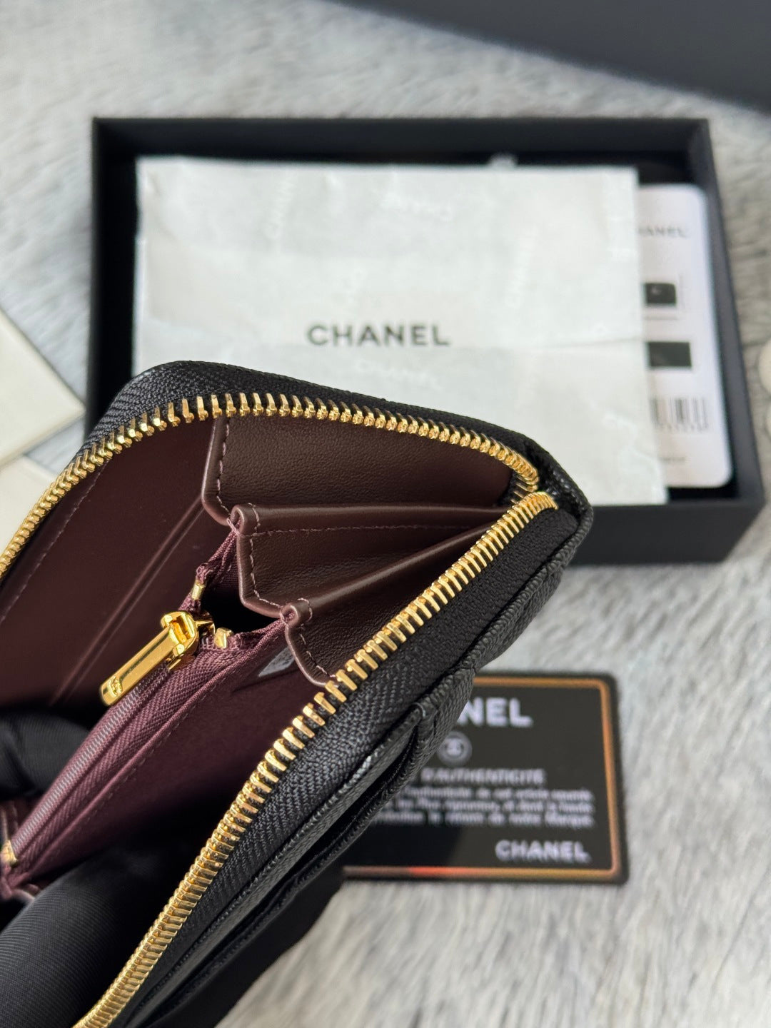 Small dark leather zip pouch with gold zipper and front pocket