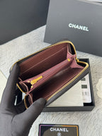 Small bag open view showing interior lining, zipper track, and gold hardware