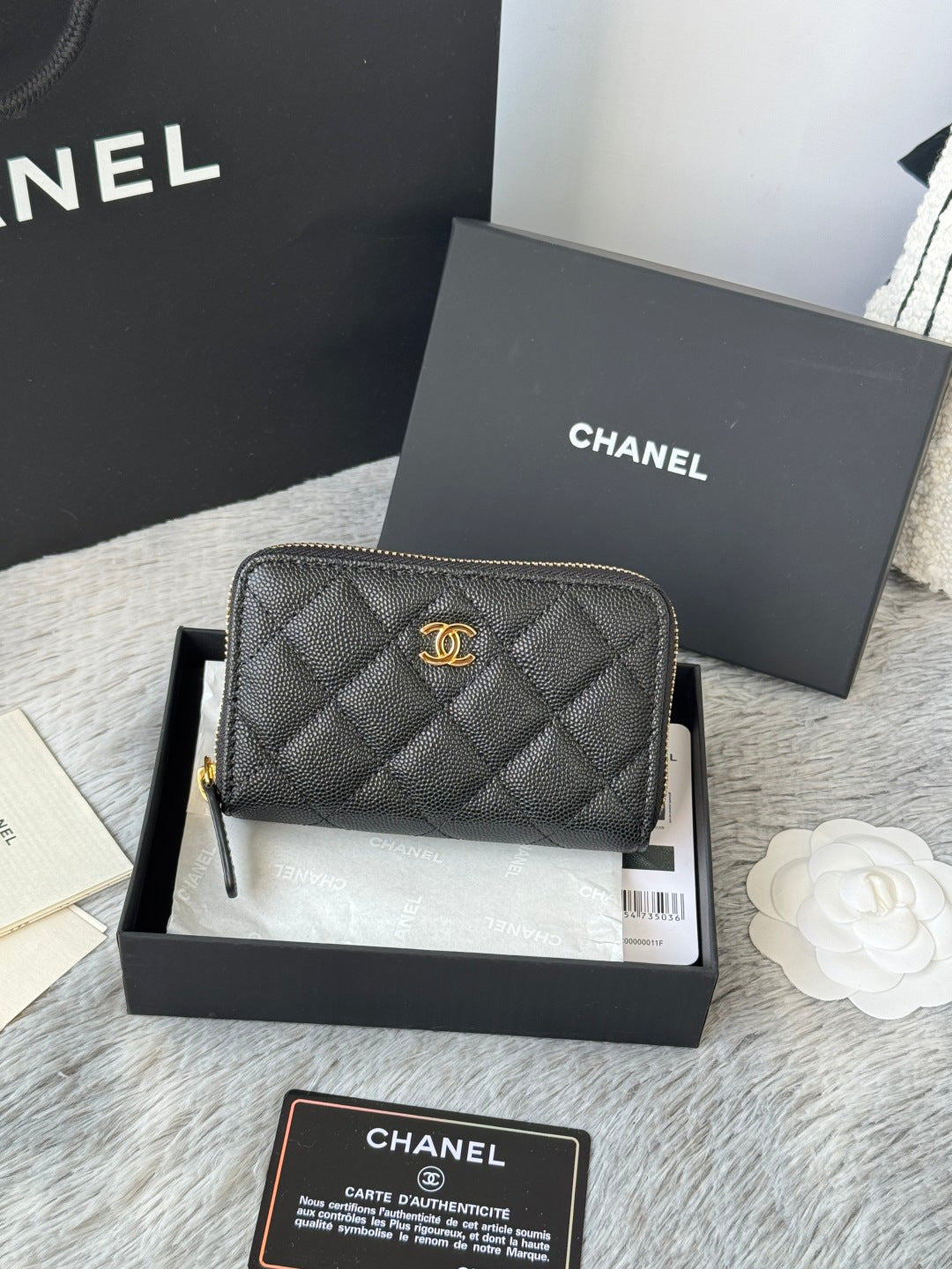 Quilted small bag with gold-tone CC emblem and zip-around closure