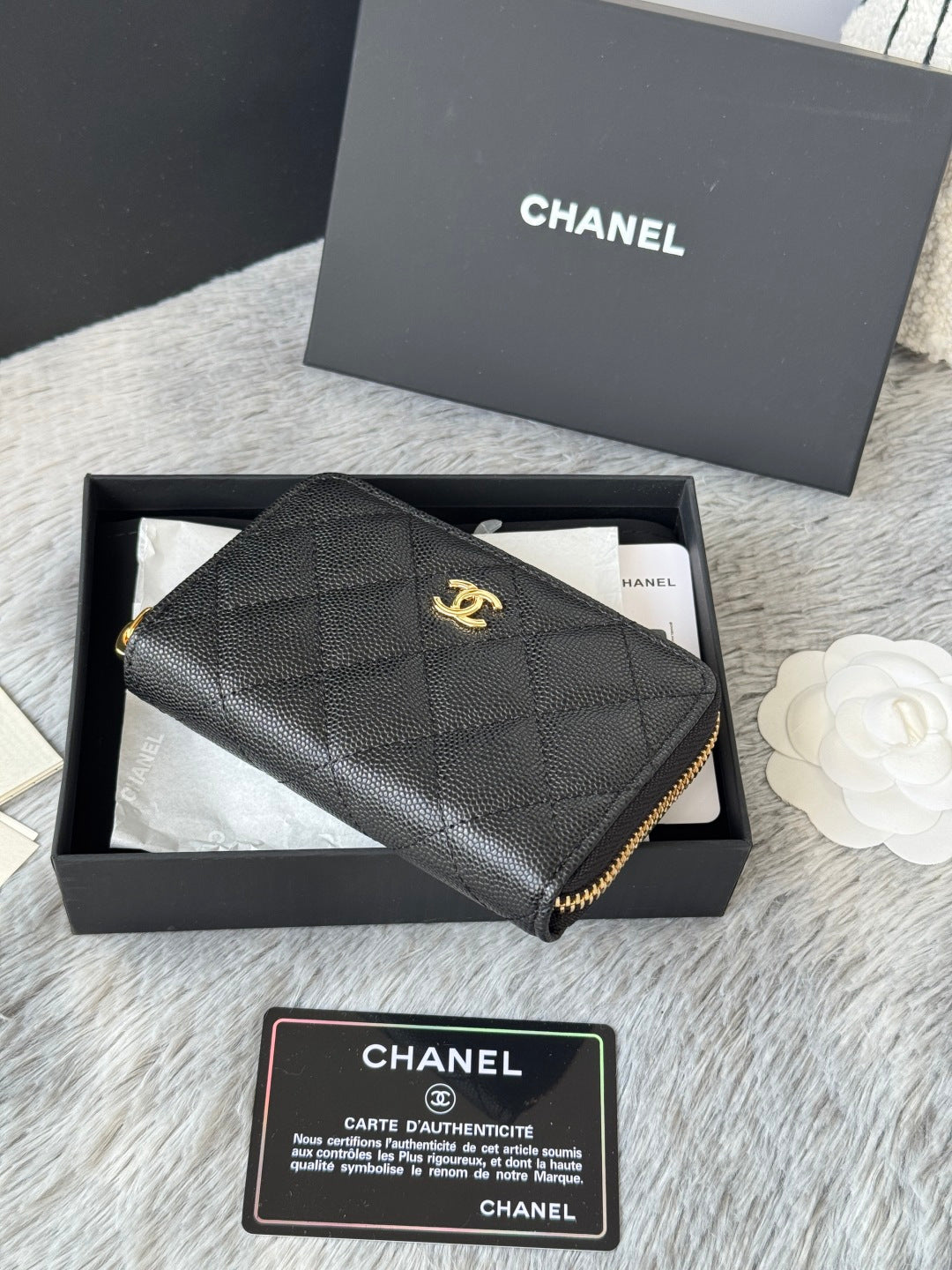 Quilted small bag side view with gold-tone zipper trim and CC emblem