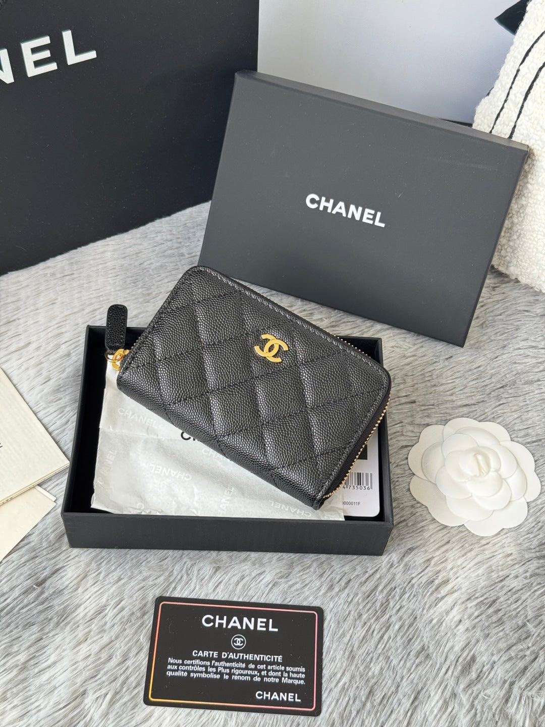 Small quilted black leather pouch with CHANEL logo, wrist strap, and gold hardware