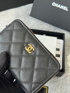 Small quilted bag corner close-up with CC logo and gold-tone zipper edge