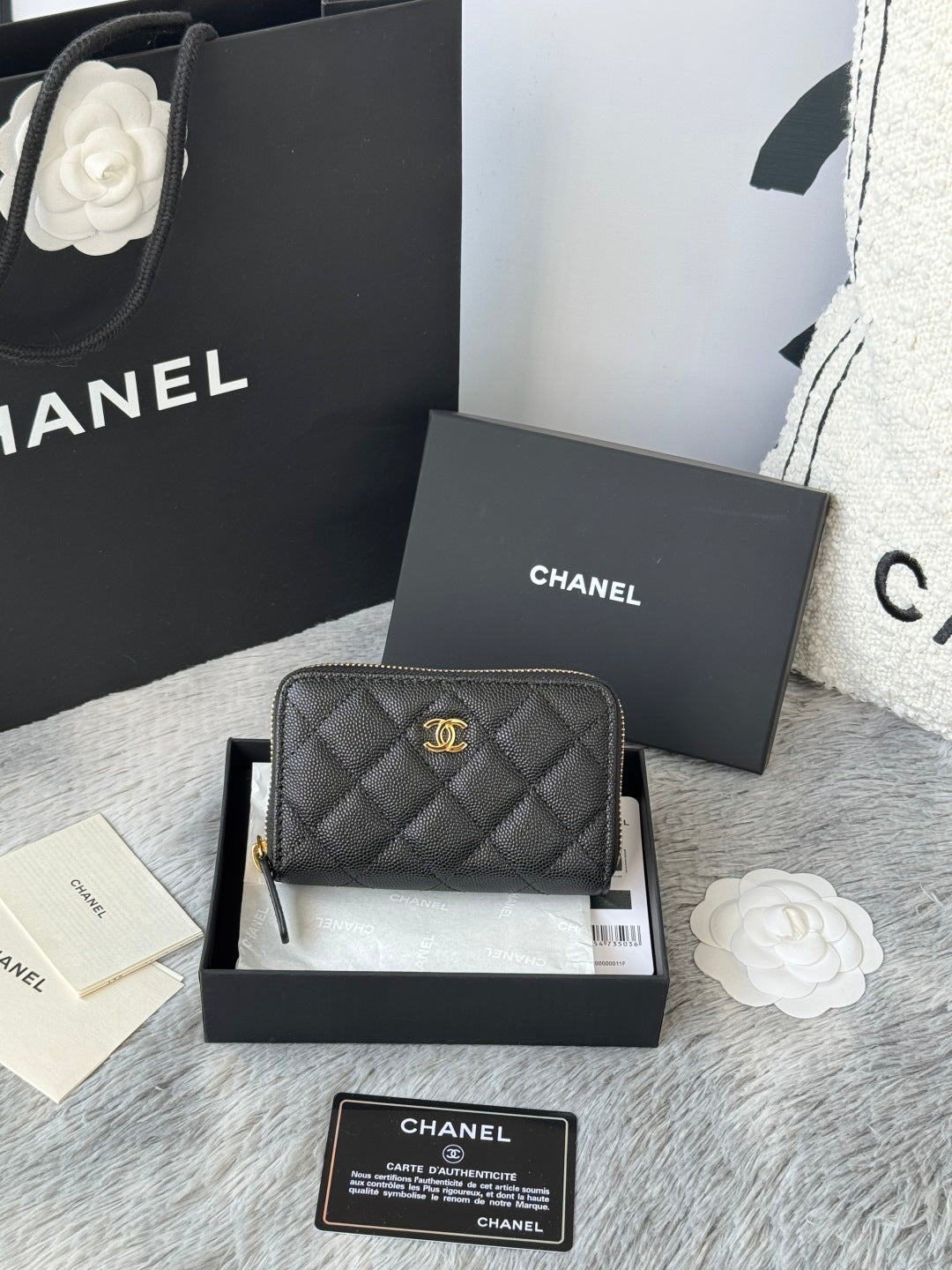 Quilted small bag with top zip closure, chain strap, and CC logo charm