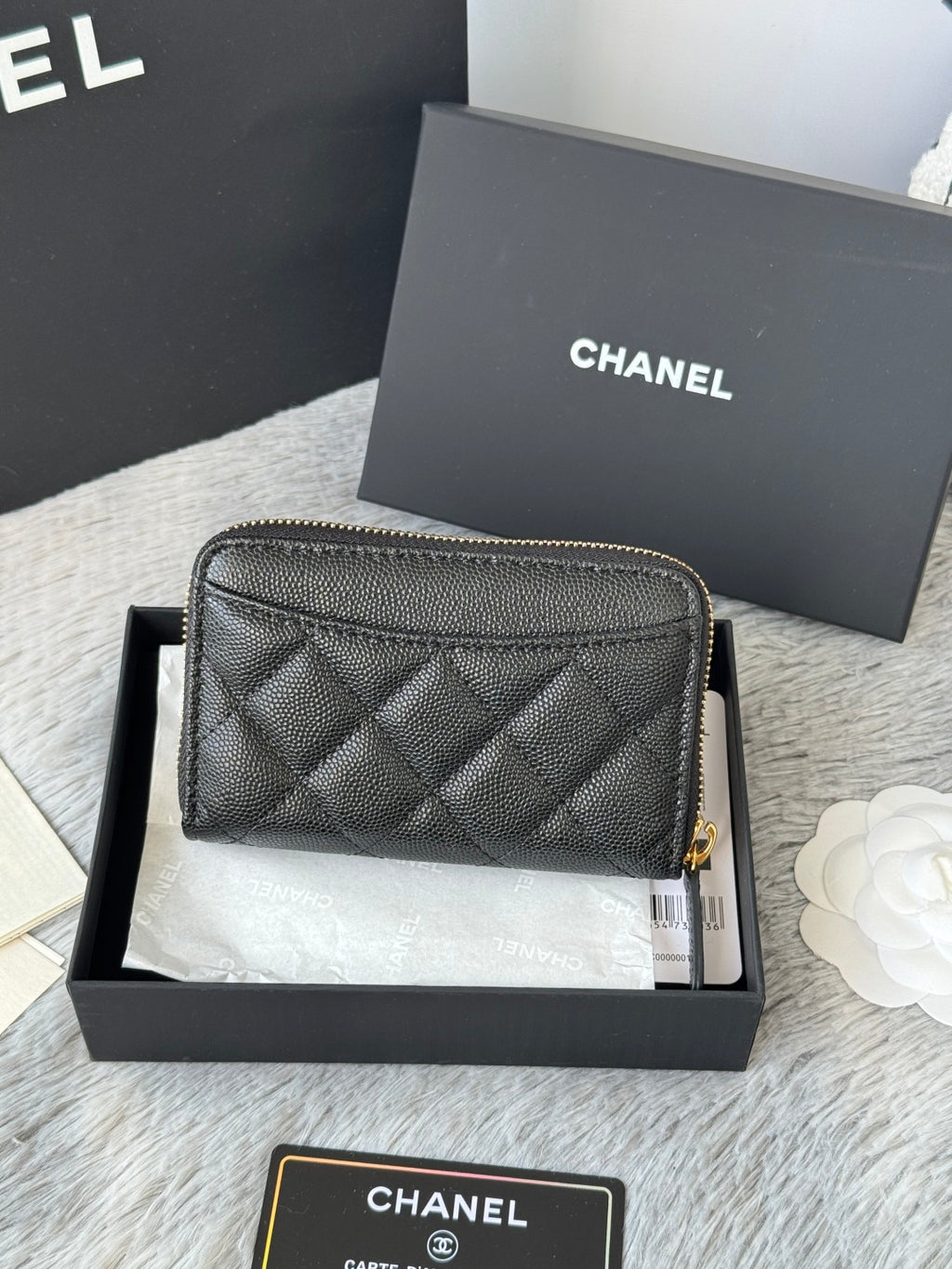 Quilted small bag front view with gold-tone zipper and CC logo on black leather