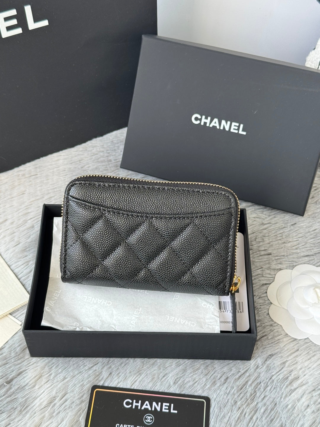 Quilted small bag front view with gold-tone zipper and CC logo on black leather