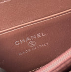 Chanel logo embossed on brown leather card pocket lining, close-up.