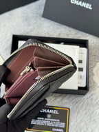 Small bag with maroon front panel, zip closure, gold-tone zipper, black strap