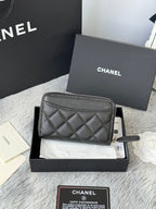 Chanel quilted small bag with zip closure and chain strap, dark black.