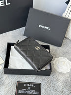 Chanel quilted small bag with zip closure and chain strap, dark black.