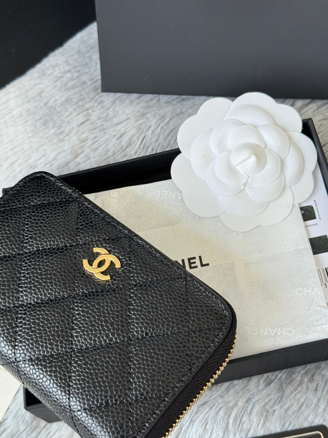 Small leather bag corner, black quilted texture with gold Chanel emblem