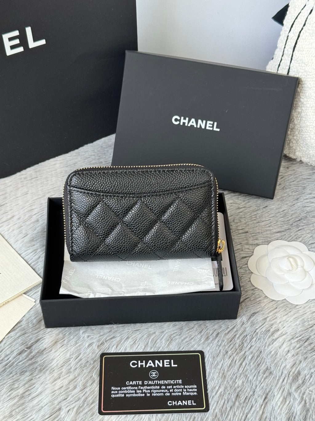 Quilted small leather bag, black, front view with gold Chanel logo
