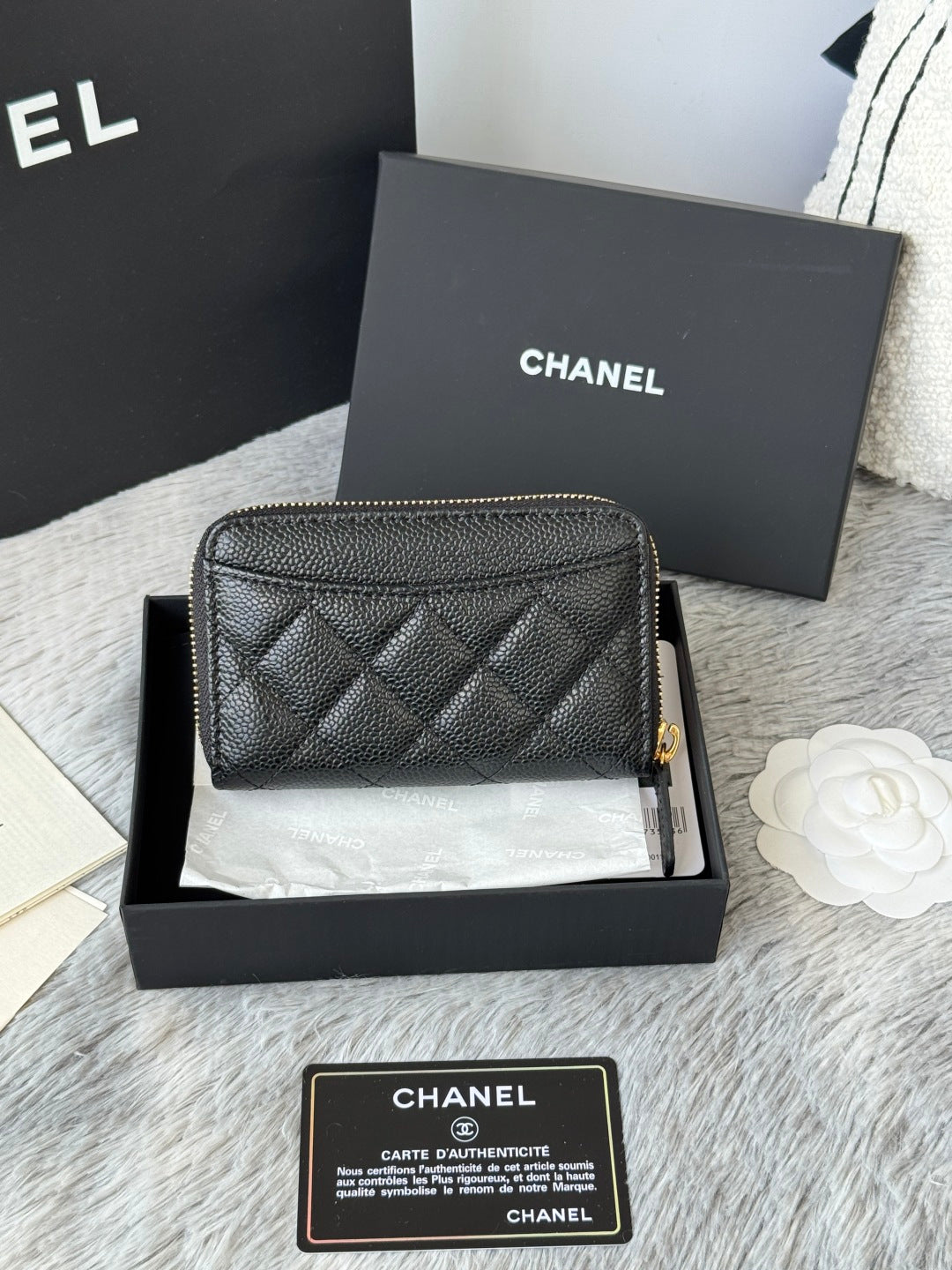 Quilted small leather bag, black, front view with gold Chanel logo