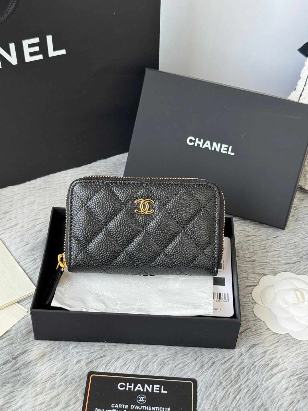 Quilted small leather bag, black with gold-tone Chanel logo and zipper top