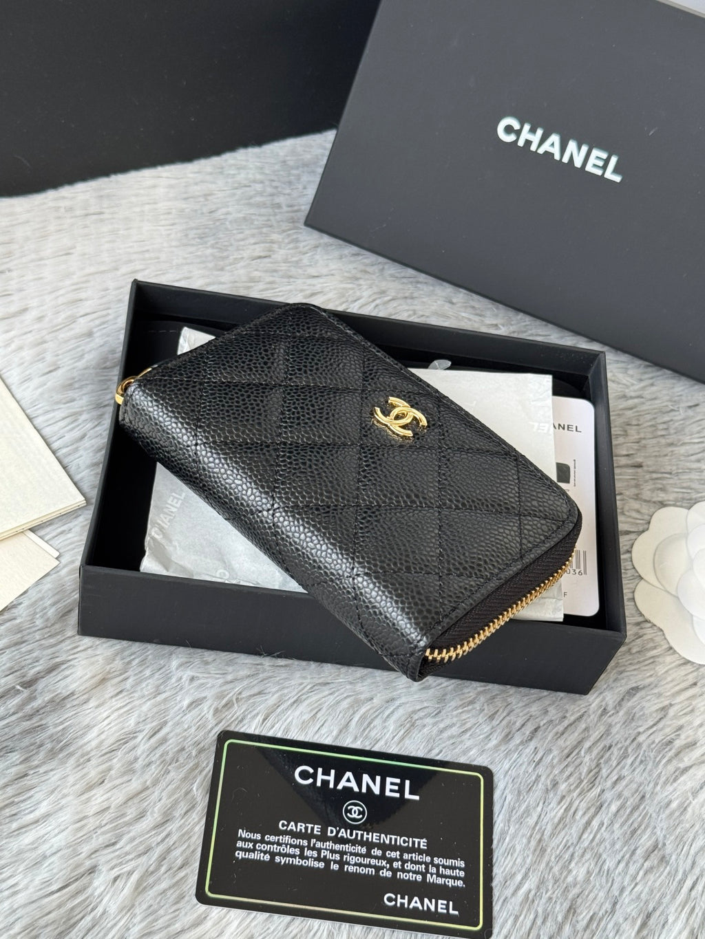 Small leather bag, black textured quilt with gold Chanel logo and zip edge
