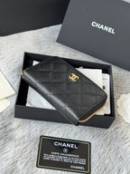 Small leather bag, black textured quilt with gold Chanel logo and zip edge