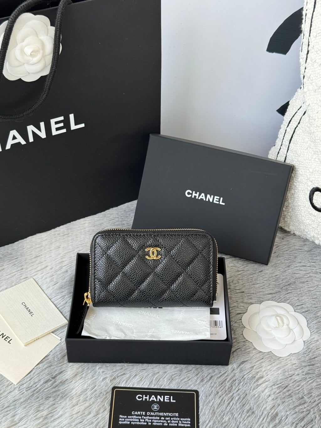 Small quilted leather bag, black with gold Chanel emblem and zip closure