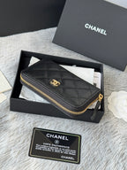 Small quilted leather bag, black with gold zipper and Chanel emblem on front