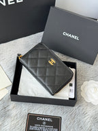 Small leather zip pouch, black with gold Chanel emblem and textured quilt pattern