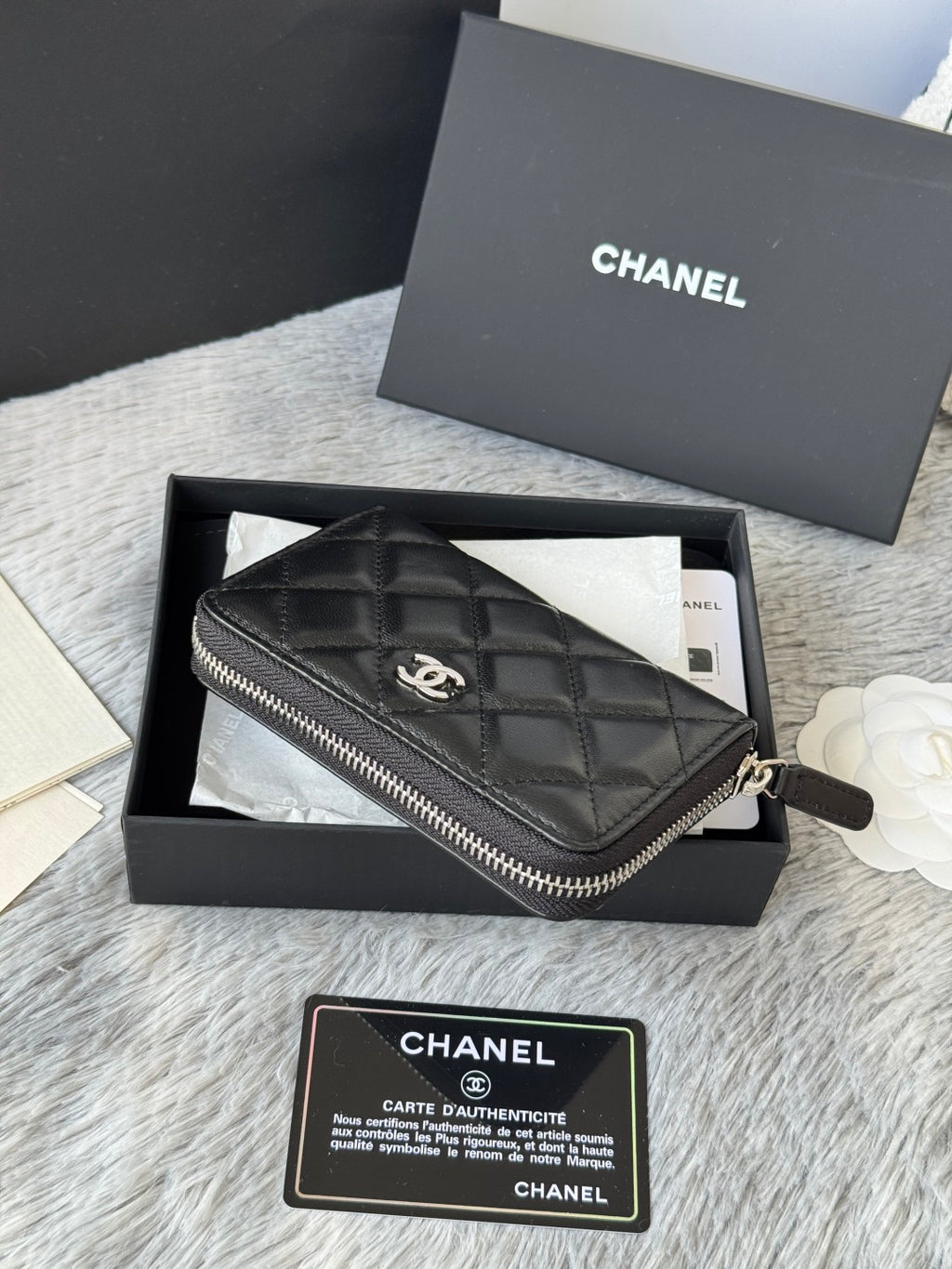 Small bag: black quilted zip wristlet pouch with CHANEL logo and zipper pull