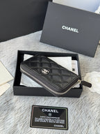 Small bag: black quilted zip wristlet pouch with CHANEL logo and zipper pull