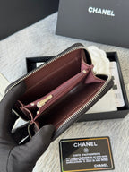 Small bag: open zip wallet pouch with burgundy lining and gold-tone hardware