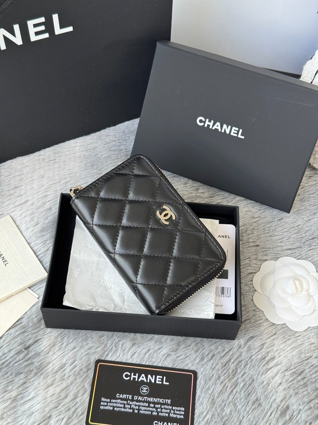 Small bag: black quilted zip pouch with CHANEL logo, gold-tone hardware