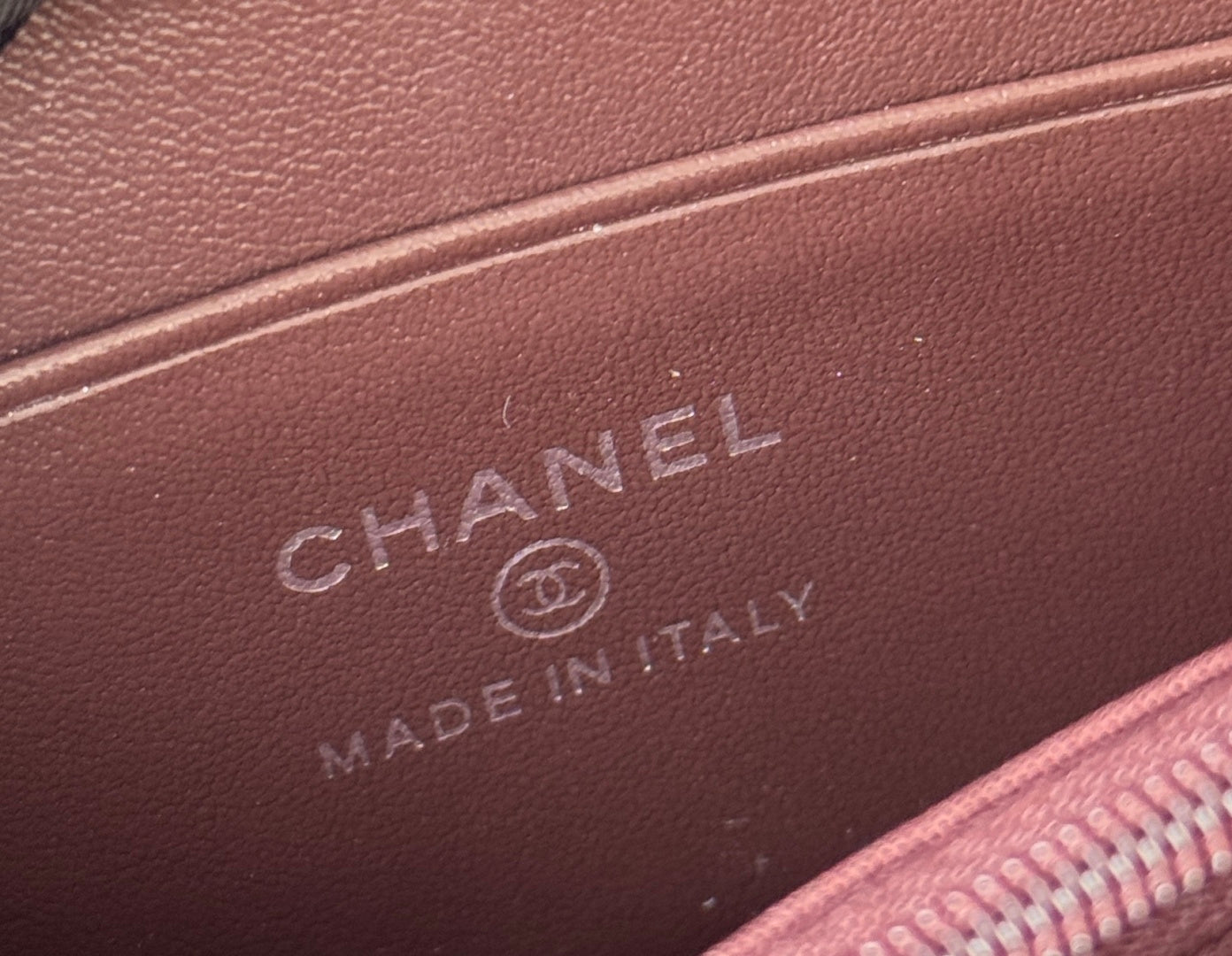 Small bag interior label with CHANEL and MADE IN ITALY on dark leather