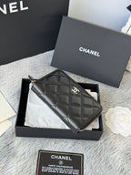 Small bag: black quilted zip pouch with CHANEL logo and chain strap, front