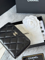 Small bag: black quilted zip pouch with CHANEL logo, close-up