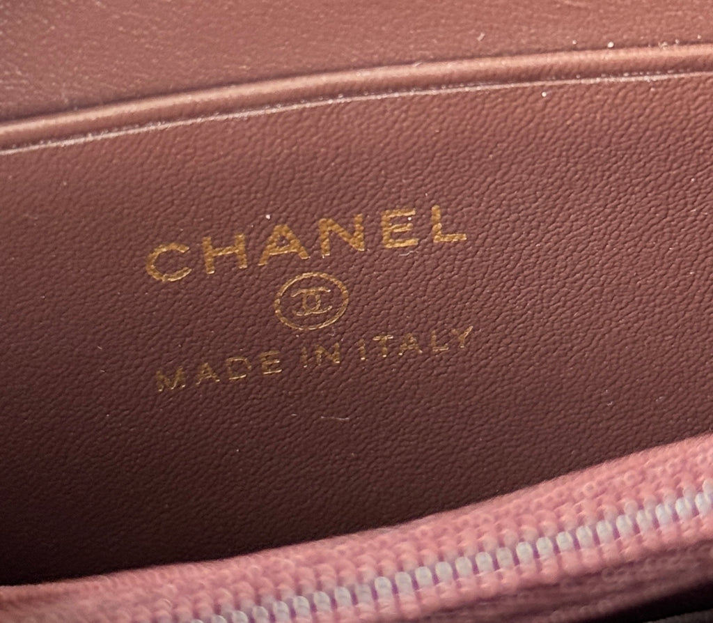 Embossed Chanel logo on brown leather wallet lining