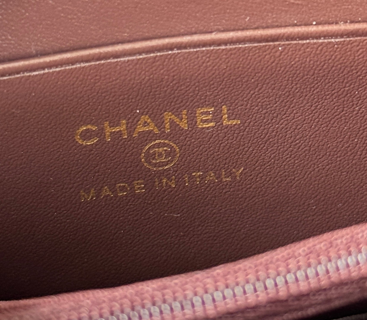 Embossed Chanel logo on brown leather wallet lining