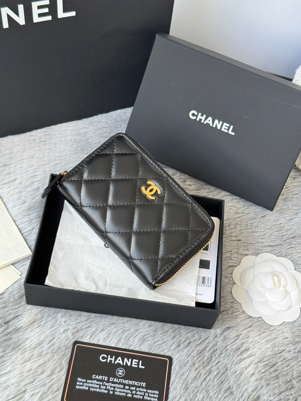 Small quilted zip wallet, dark leather with gold-tone logo and zipper