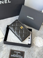 Small quilted zip wallet, dark leather with gold-tone logo and zipper