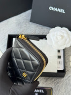 Small quilted zip wallet side view, dark leather with gold-tone zipper