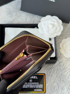Burgundy small bag interior view, gold-tone zipper edge, black strap, hanging charm
