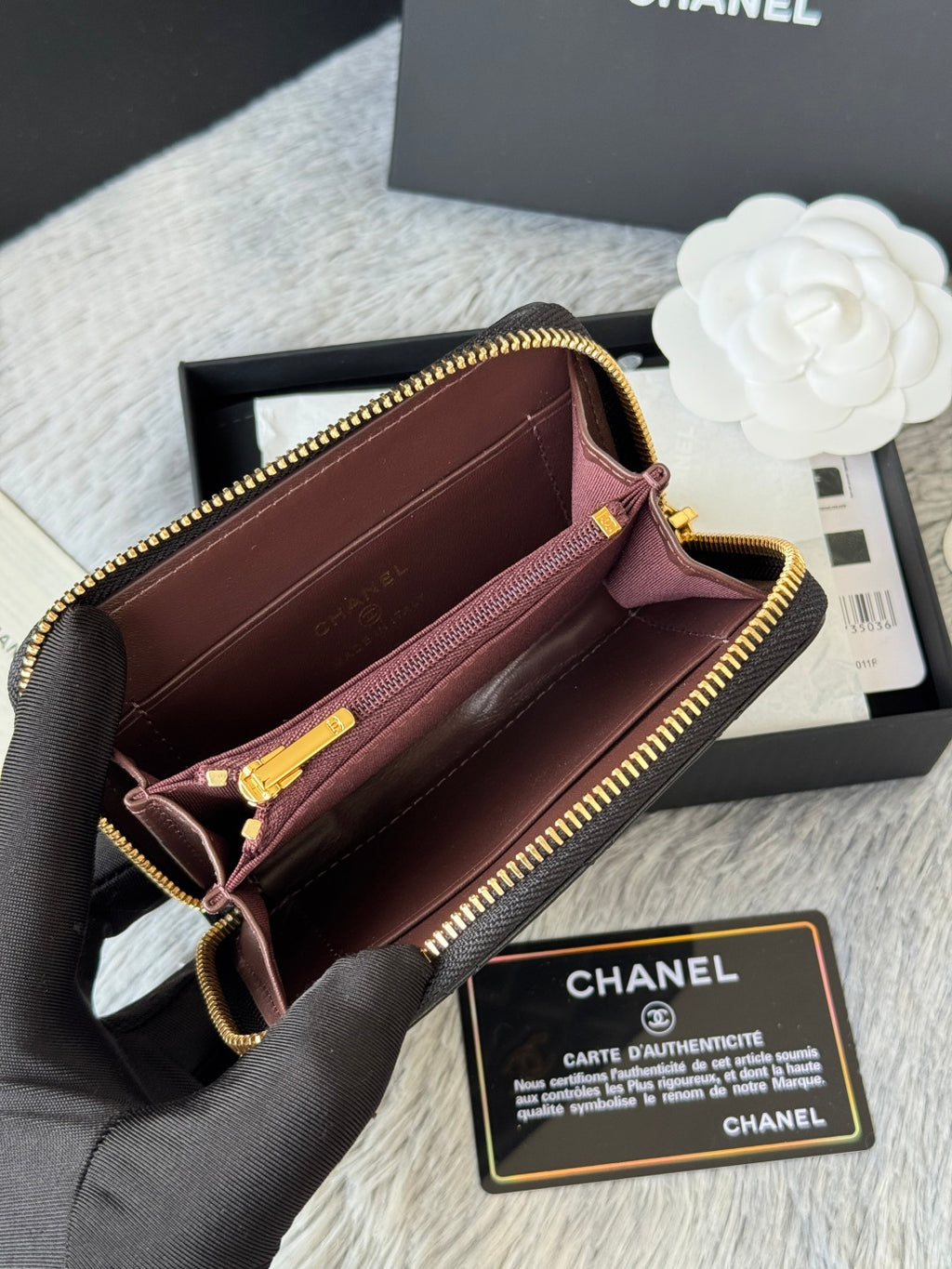 Burgundy small bag with gold-tone zipper, crossbody strap, open interior with pocket