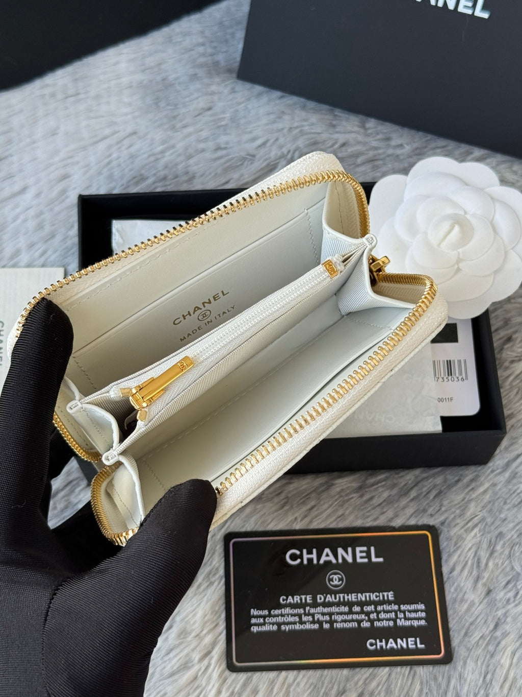 White quilted small bag open view with beige interior and gold zip track