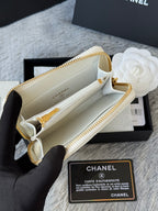White quilted small bag open view with beige interior and gold zip track
