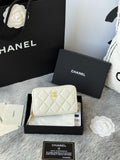 White quilted small bag with gold chain strap, CC logo, and zip closure