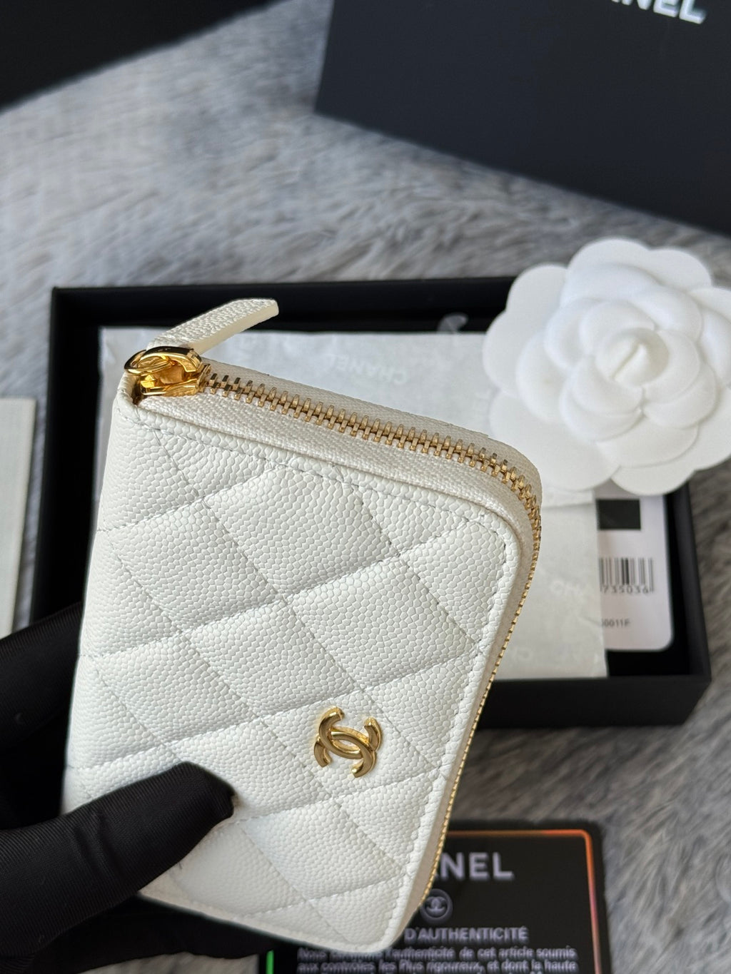 White quilted small bag close-up with gold zipper and gold CC logo hardware