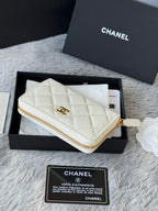 White quilted small bag with gold wrist strap and gold-tone zipper detail