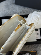 Small bag open interior with gold-tone zipper, clasp, and light-colored lining