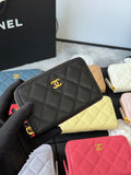 Small quilted zip wallet in dark gray/black leather with gold CC logo and zipper.