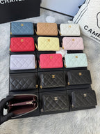 Assorted small quilted zip wallets in multiple colors, arranged in rows with gold logos.