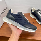 Givenchy navy sneaker with white laces, quilted side panels, and thick outsole