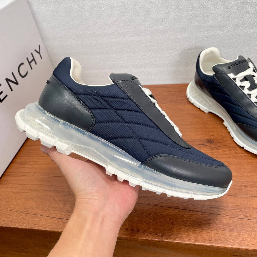 Givenchy navy sneaker with white laces, quilted side panels, and thick outsole